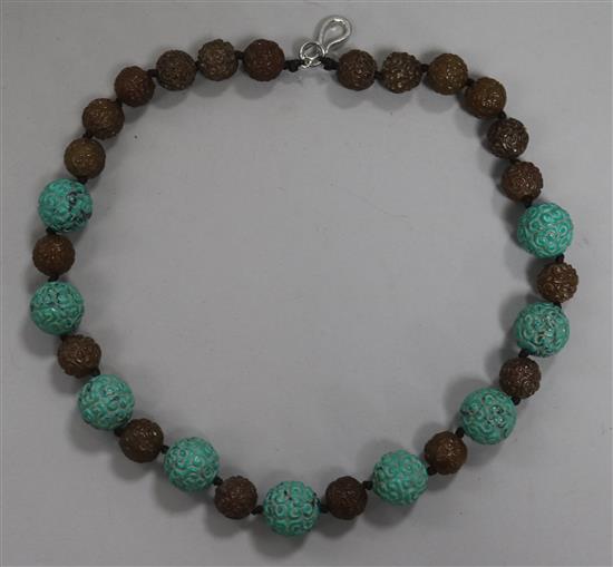 A carved turquoise and agate bead necklace.